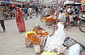 Varanasi - pilgrims purchasing flowers for puja 